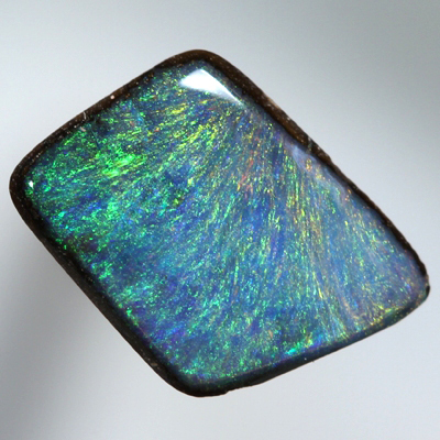 SOLID BOULDER OPAL Bright orange and green sparkles over blue